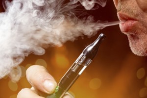close up portrait of a man smoking an e-cigarette